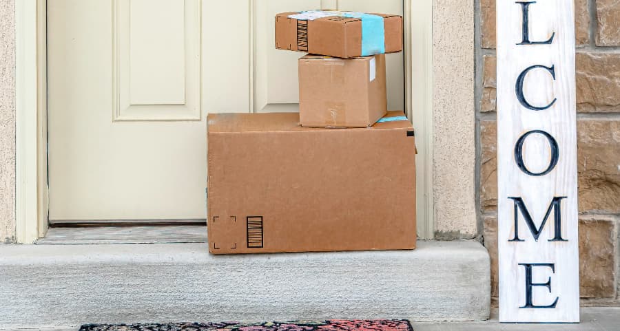 Deliveries on the front porch of a house with a welcome sign in Charlotte